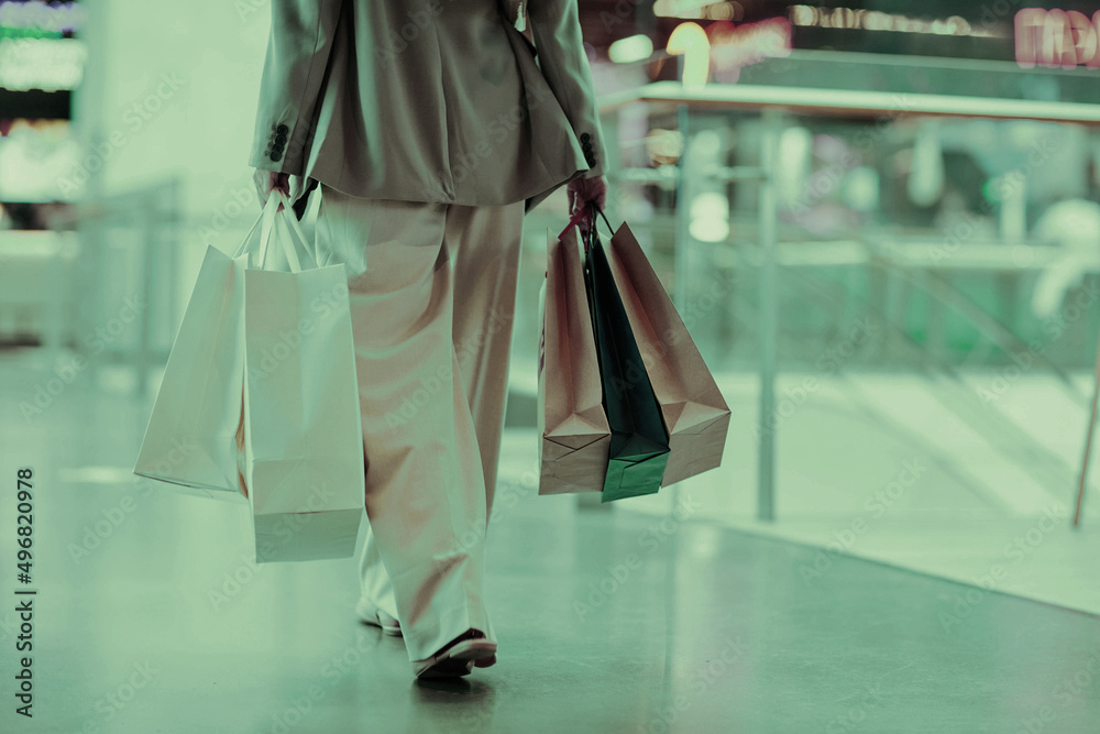 Shopper carrying bags through a retail centre
